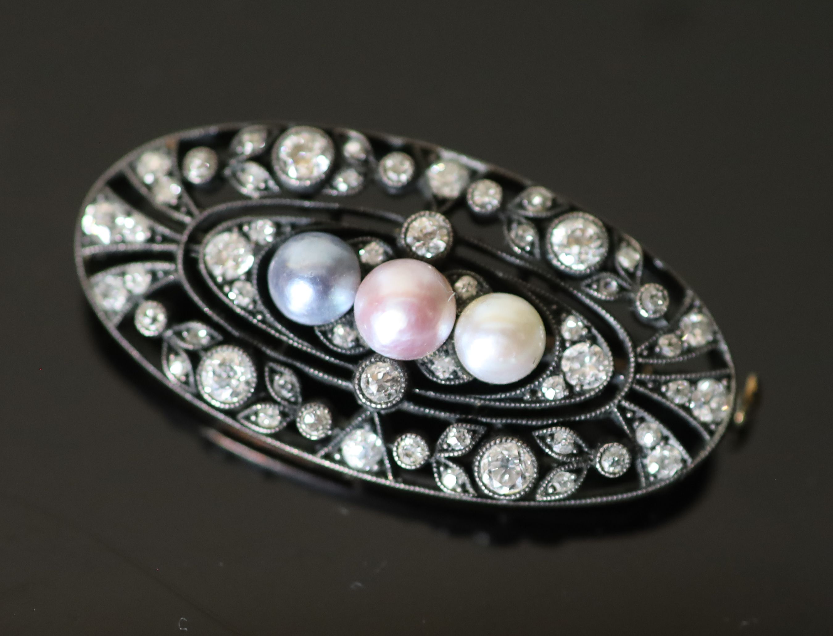 An early 20th century gold and silver, diamond and three colour split pearl set oval openwork brooch,